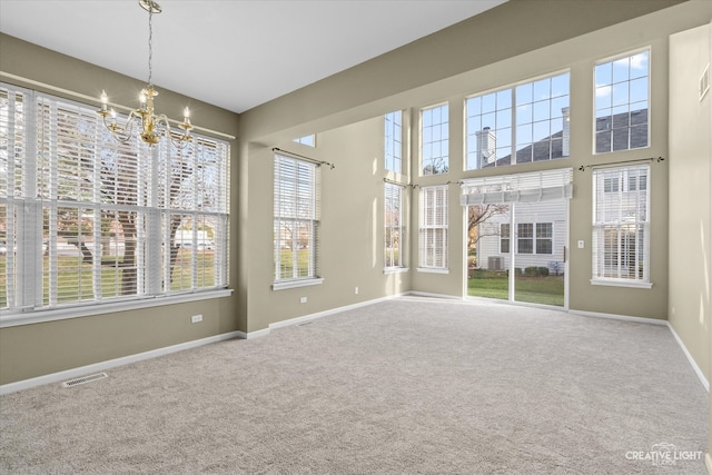 unfurnished sunroom featuring a notable chandelier and plenty of natural light