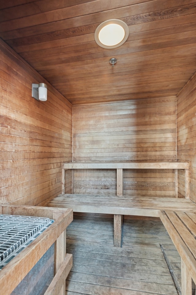 view of sauna featuring wood walls, wood-type flooring, and wooden ceiling