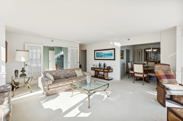 living room with a chandelier and french doors