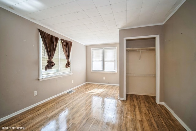 23525 W Briar Ter, Antioch, IL 60002 - unfurnished bedroom featuring crown molding, a closet, wood finished floors, and baseboards