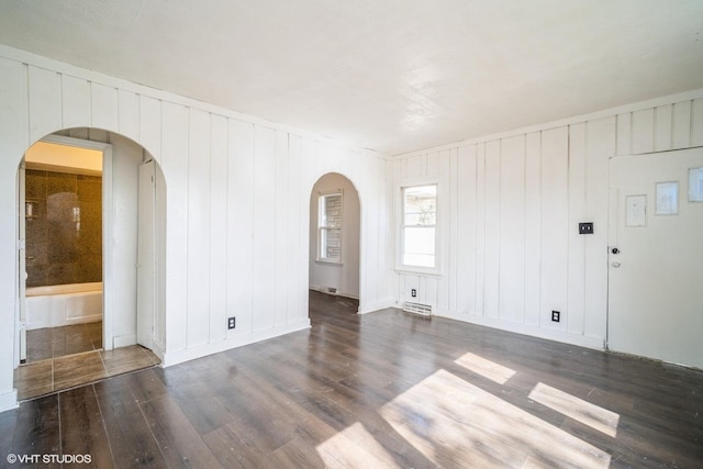 23525 W Briar Ter, Antioch, IL 60002 - unfurnished room with arched walkways, wood finished floors, and baseboards