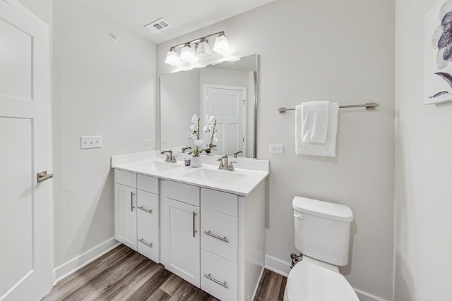 bathroom featuring hardwood / wood-style flooring, vanity, and toilet