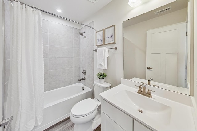 full bathroom featuring hardwood / wood-style flooring, vanity, toilet, and shower / bathtub combination with curtain