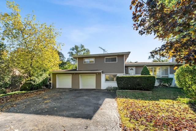 split level home featuring an attached garage and driveway