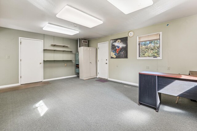 basement featuring wooden walls and a drop ceiling