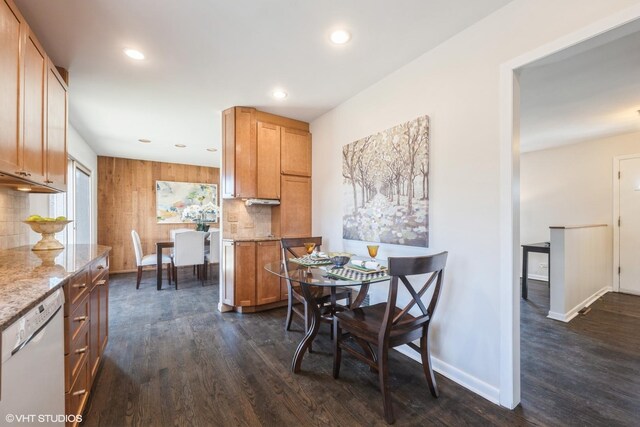 kitchen featuring dishwasher, dark hardwood / wood-style flooring, sink, light stone countertops, and stove