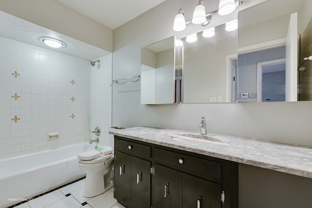 full bathroom with tile patterned floors, toilet, vanity, and tiled shower / bath