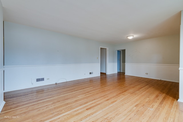 empty room with light hardwood / wood-style flooring