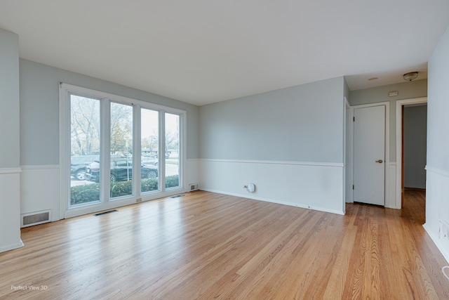 unfurnished room with light hardwood / wood-style floors