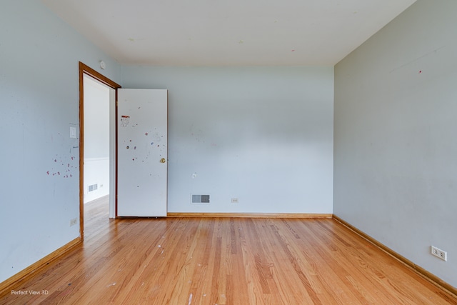 unfurnished room with light wood-type flooring