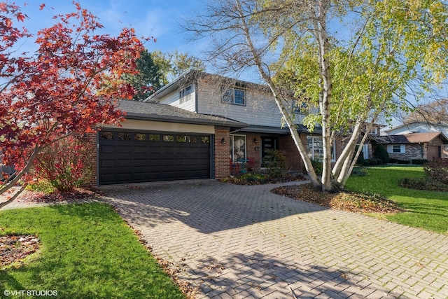 view of front property with a garage and a front yard