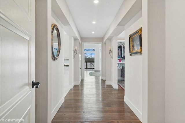 hall featuring recessed lighting, baseboards, and dark wood finished floors