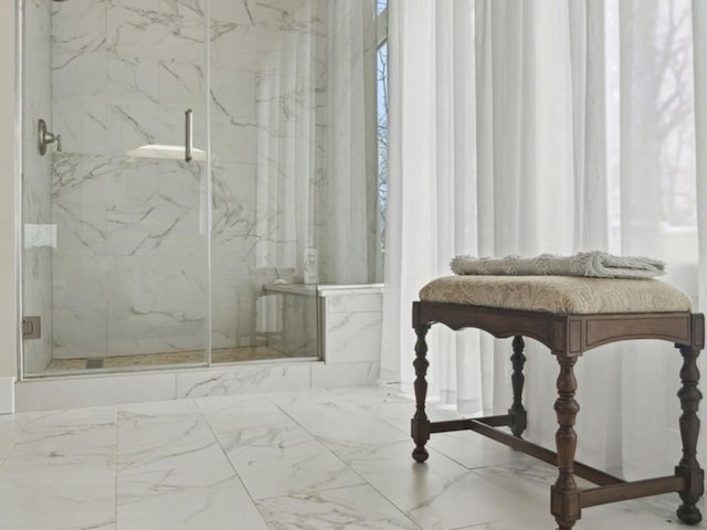 bathroom featuring a marble finish shower and marble finish floor