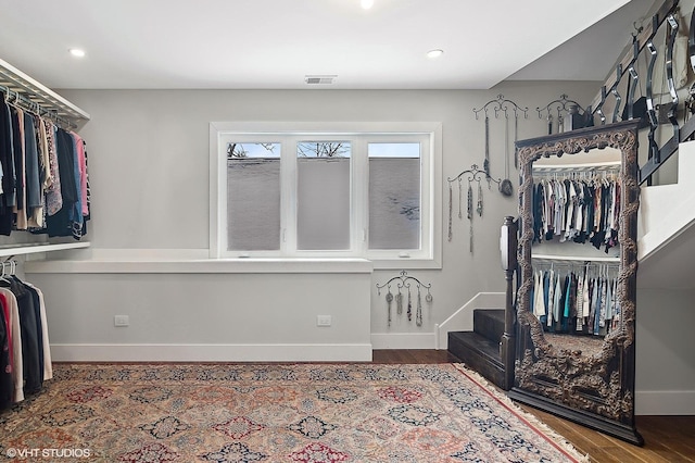 spacious closet featuring visible vents and wood finished floors