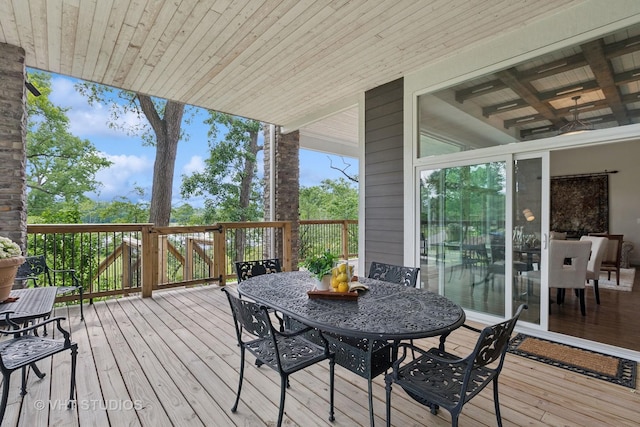 wooden terrace with outdoor dining area