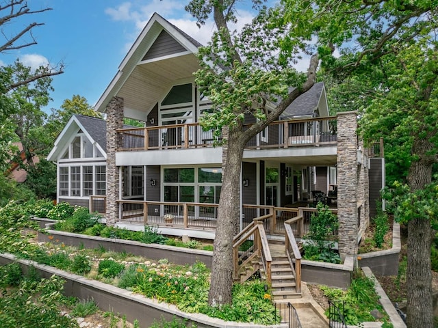 back of property with stairway and roof with shingles