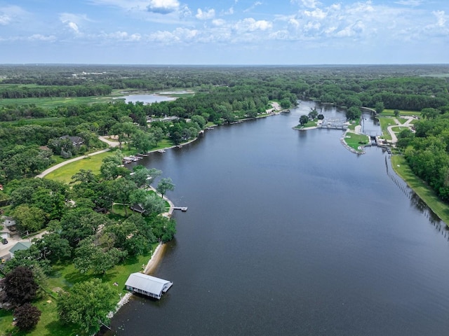 aerial view with a forest view and a water view