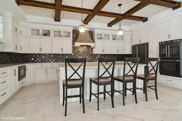 kitchen featuring premium range hood, black appliances, marble finish floor, white cabinetry, and tasteful backsplash