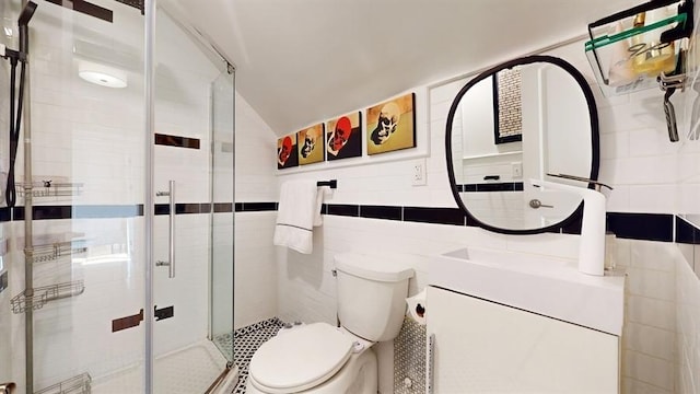 bathroom featuring lofted ceiling, tile walls, an enclosed shower, and toilet