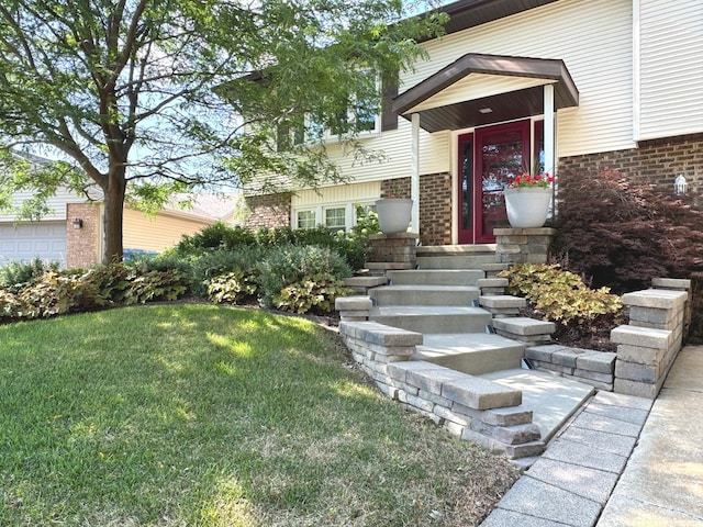 doorway to property featuring a lawn