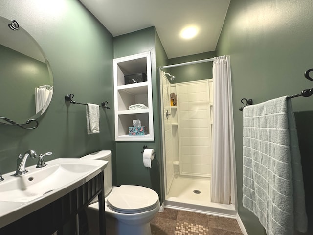 bathroom featuring walk in shower, vanity, toilet, and tile patterned floors