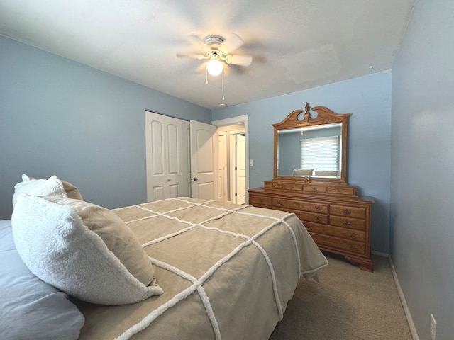 carpeted bedroom featuring ceiling fan and a closet