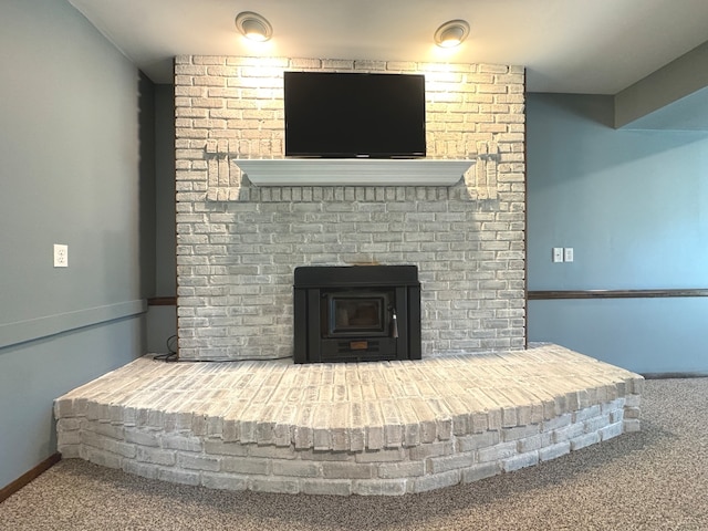 details featuring a wood stove and carpet floors