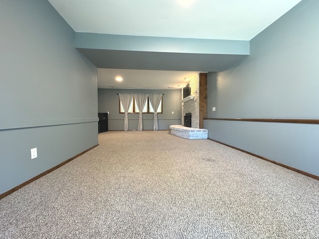 interior space with a brick fireplace and carpet floors