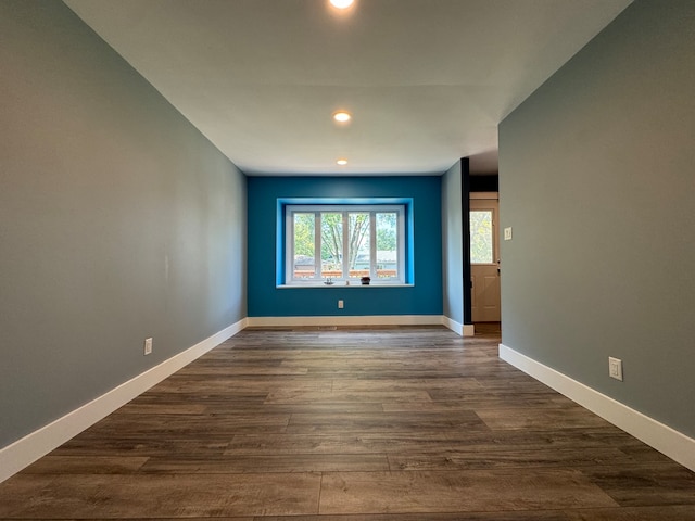 empty room featuring dark hardwood / wood-style flooring