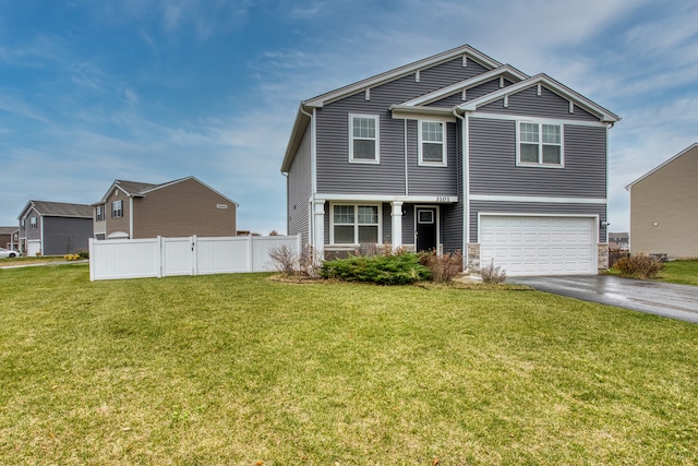 view of front of home with a garage and a front yard