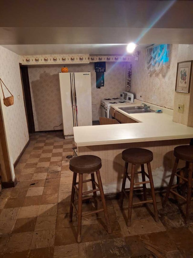 bar featuring white appliances and sink