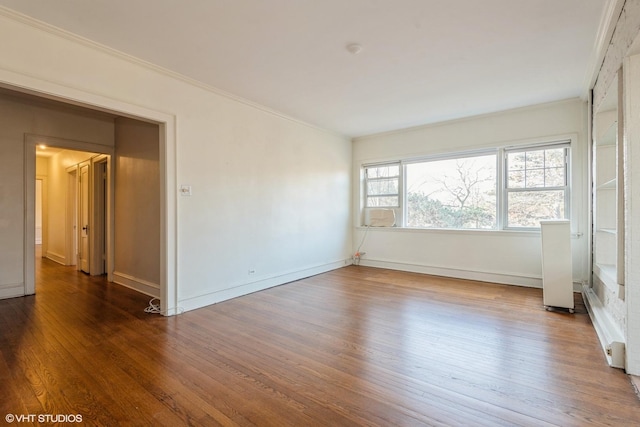 unfurnished room featuring dark hardwood / wood-style flooring and ornamental molding