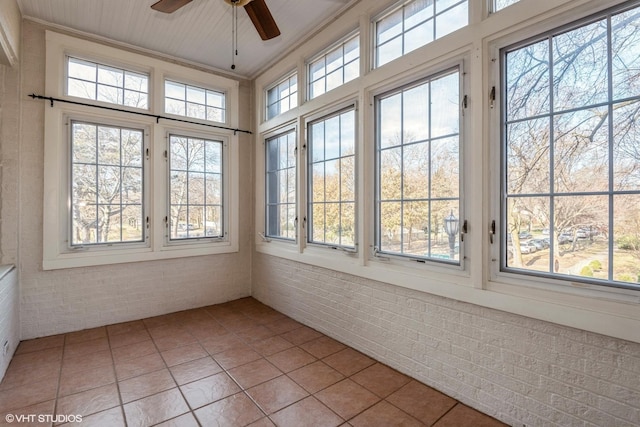 unfurnished sunroom with plenty of natural light and ceiling fan