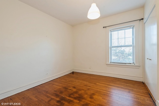 empty room with hardwood / wood-style flooring