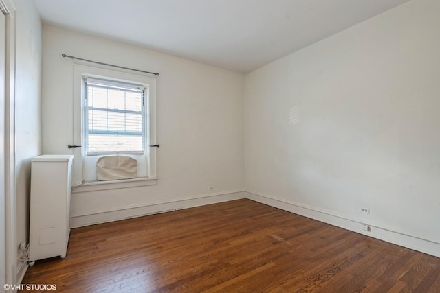 unfurnished room featuring dark hardwood / wood-style flooring