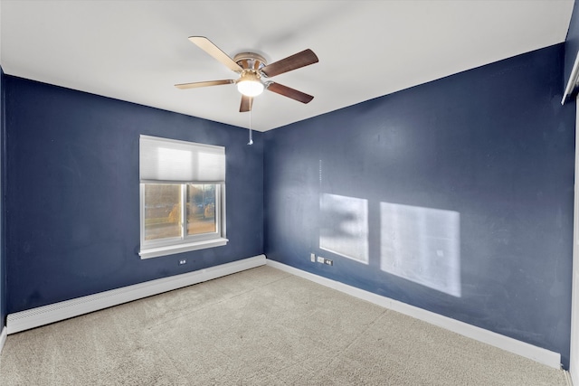 spare room featuring light carpet, ceiling fan, and a baseboard heating unit