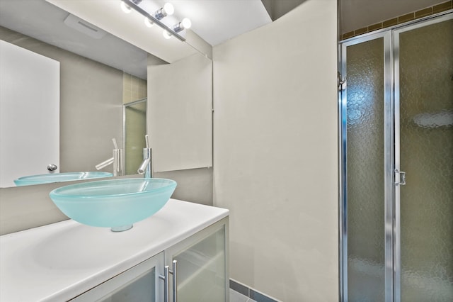 bathroom featuring vanity and a shower with door