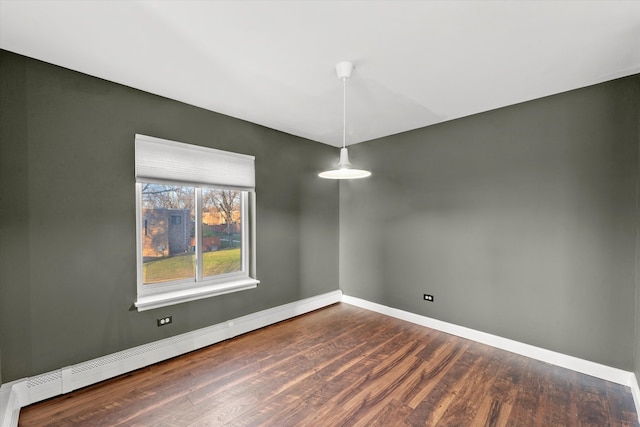 unfurnished dining area with a baseboard radiator and dark wood-type flooring