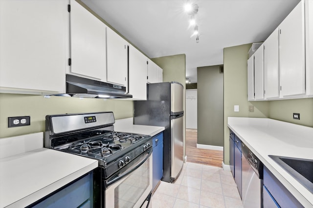 kitchen with white cabinets, appliances with stainless steel finishes, light hardwood / wood-style floors, and sink