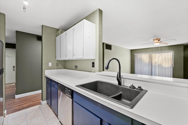 kitchen with white cabinetry, dishwasher, sink, blue cabinets, and light wood-type flooring