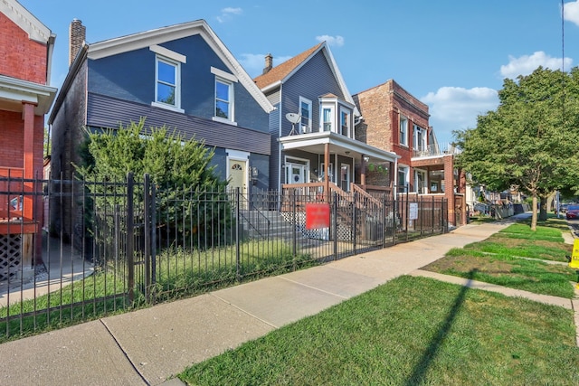 view of front of home featuring covered porch and a front lawn