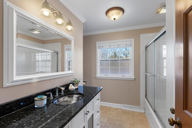 bathroom with tile patterned flooring, ornamental molding, vanity, and shower / bath combination with glass door