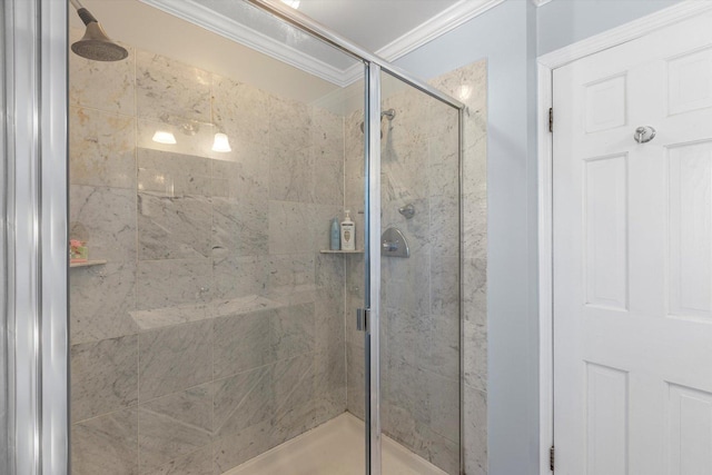 bathroom featuring a shower with door and ornamental molding