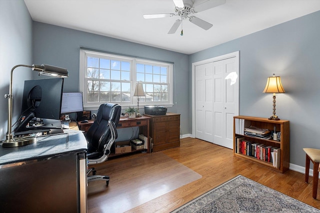 office area with ceiling fan and light hardwood / wood-style flooring