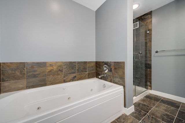 full bathroom with a stall shower, a whirlpool tub, and baseboards