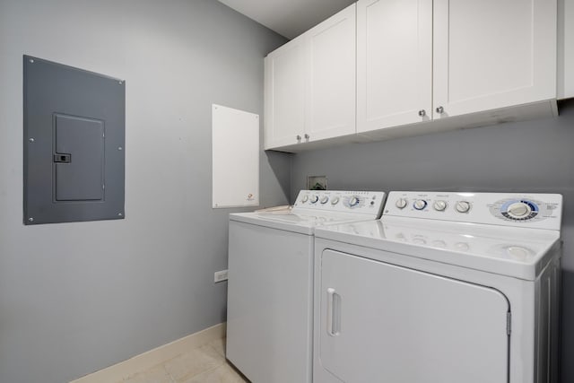 laundry area featuring cabinet space, light tile patterned flooring, washer and dryer, electric panel, and baseboards