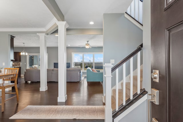 entryway with decorative columns, dark hardwood / wood-style flooring, a textured ceiling, and ceiling fan with notable chandelier