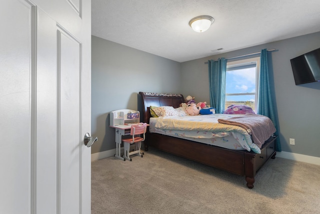 bedroom with light carpet and a textured ceiling