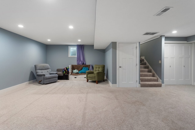 sitting room featuring light carpet