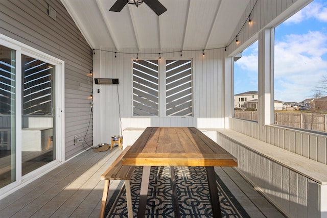 unfurnished sunroom with ceiling fan and lofted ceiling